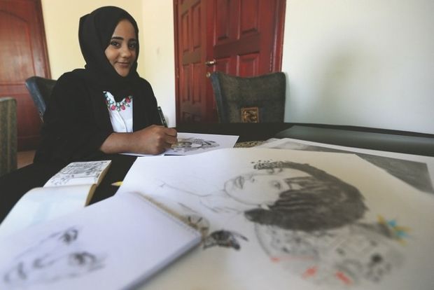Fatima Farah with her artwork